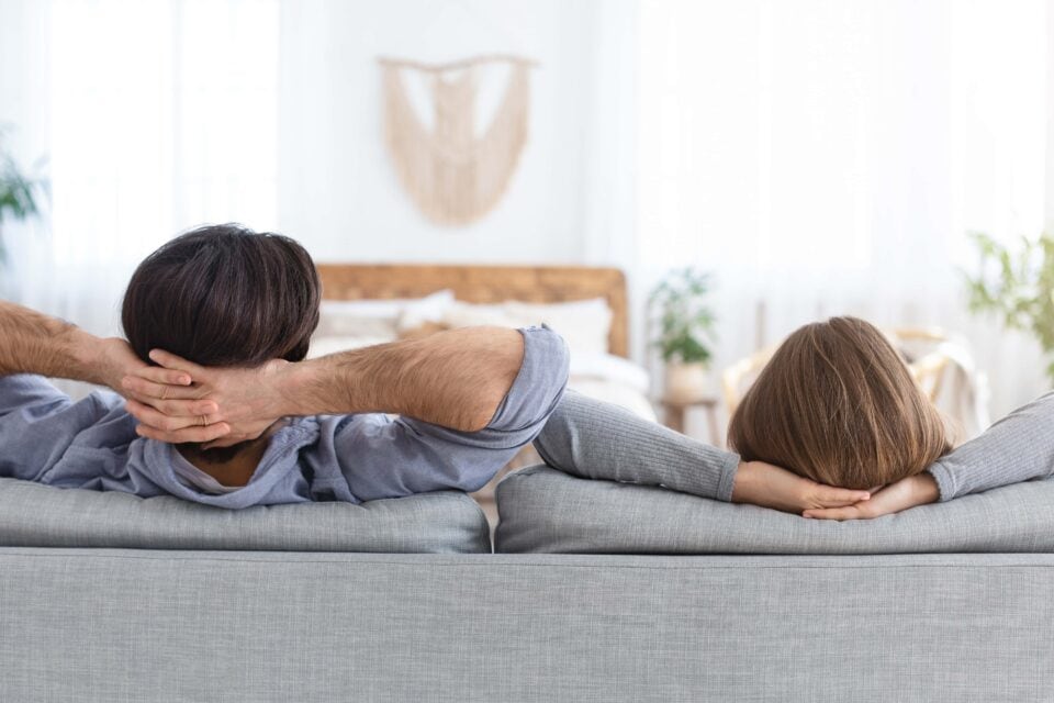 Back view of relaxed man and woman resting at home